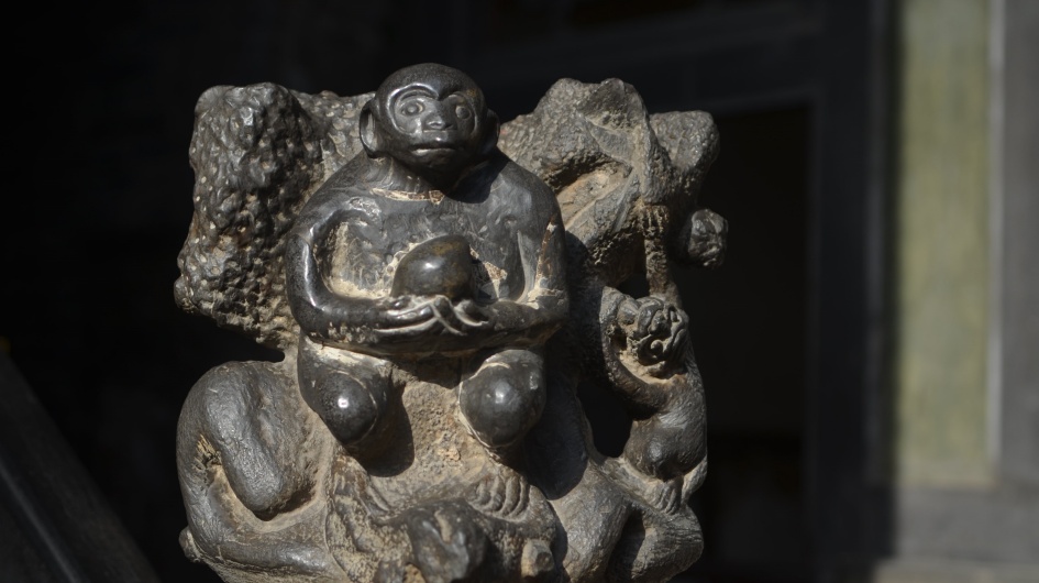 The stone carving of monkeys holding peaches at the Wang Family Compound.