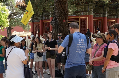 The tour guide is explaining the history of the Forbidden City